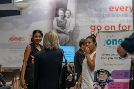 Group talking at The Jones Center event, with a focus on community, learning, and engagement.