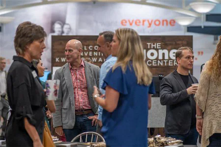 People networking at a professional event, engaging in conversations and exchanging ideas.