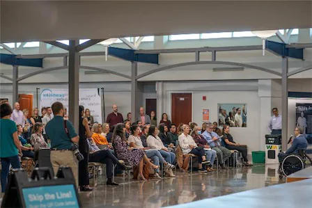 Audience attending a presentation in a modern conference room.