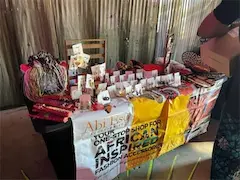 Colorful market stall displaying African-inspired fashion accessories and jewelry.