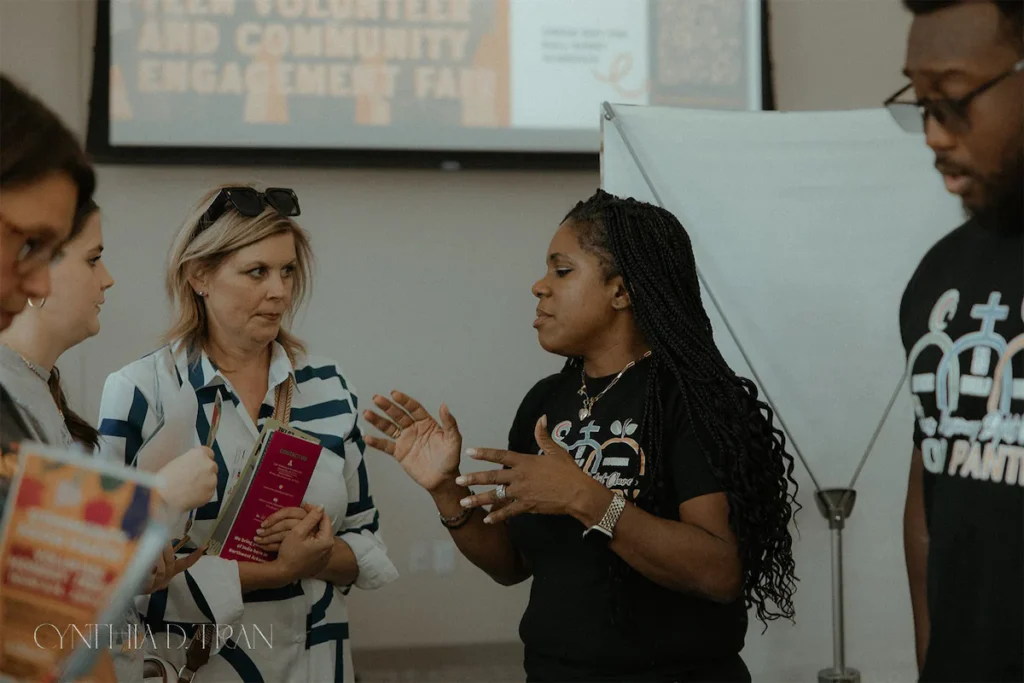 People networking at a volunteer and community engagement fair event.