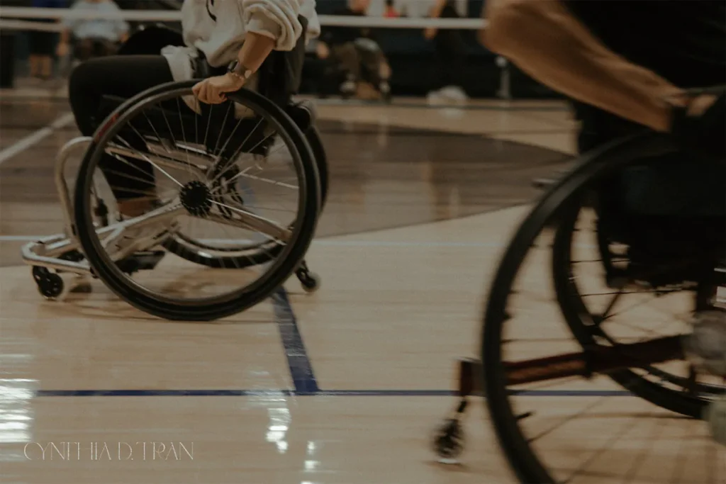 Wheelchair basketball players in action on a court, highlighting dynamic movement and sportsmanship.